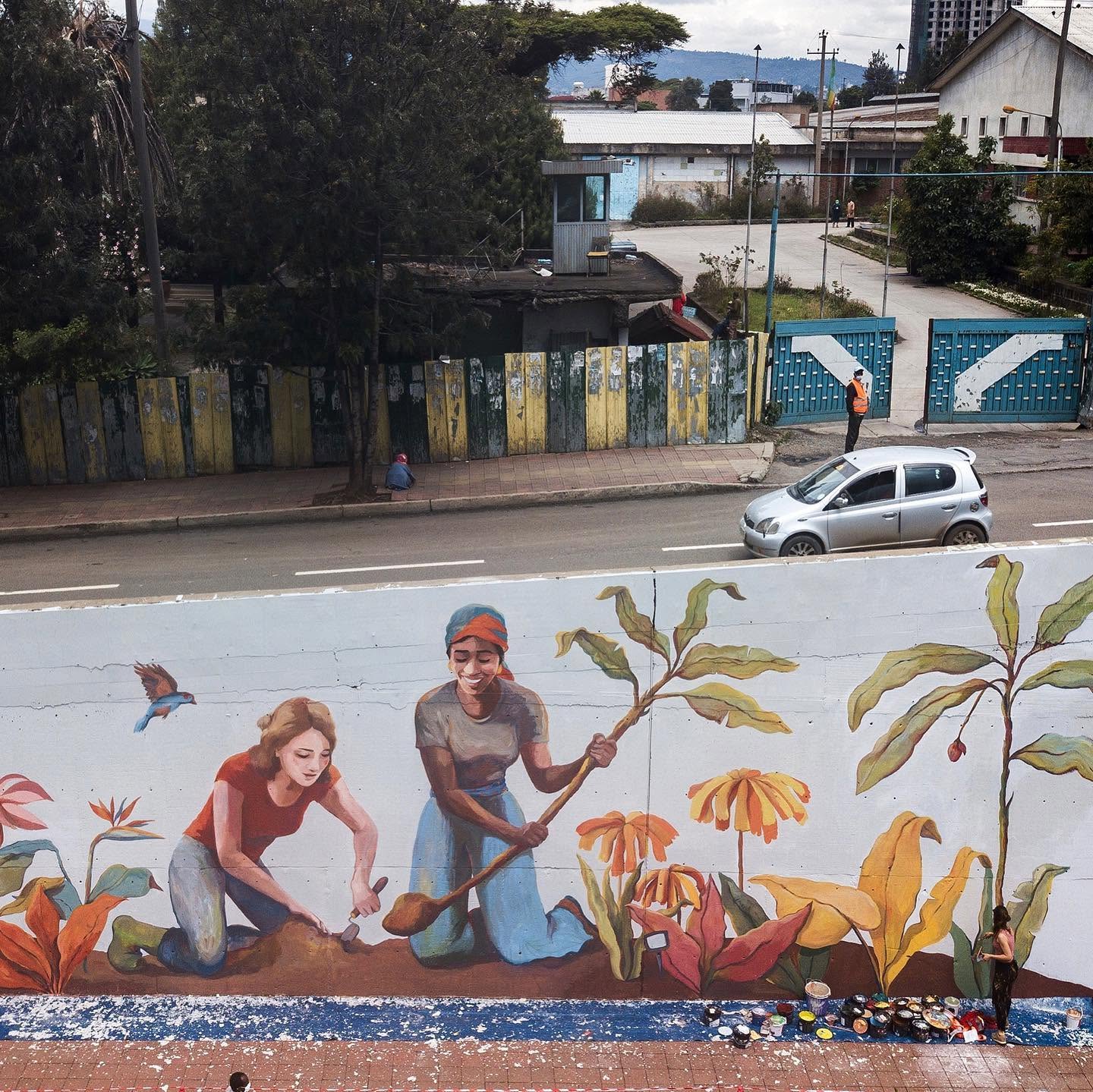 Street Heart — the planting mural seen from across the road, paint pots still out