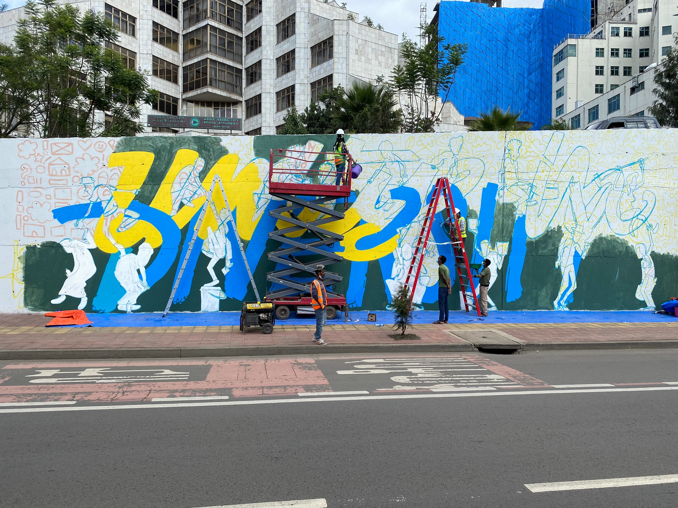 Street Heart — scissor lift, ladders and outline work, mid-paint