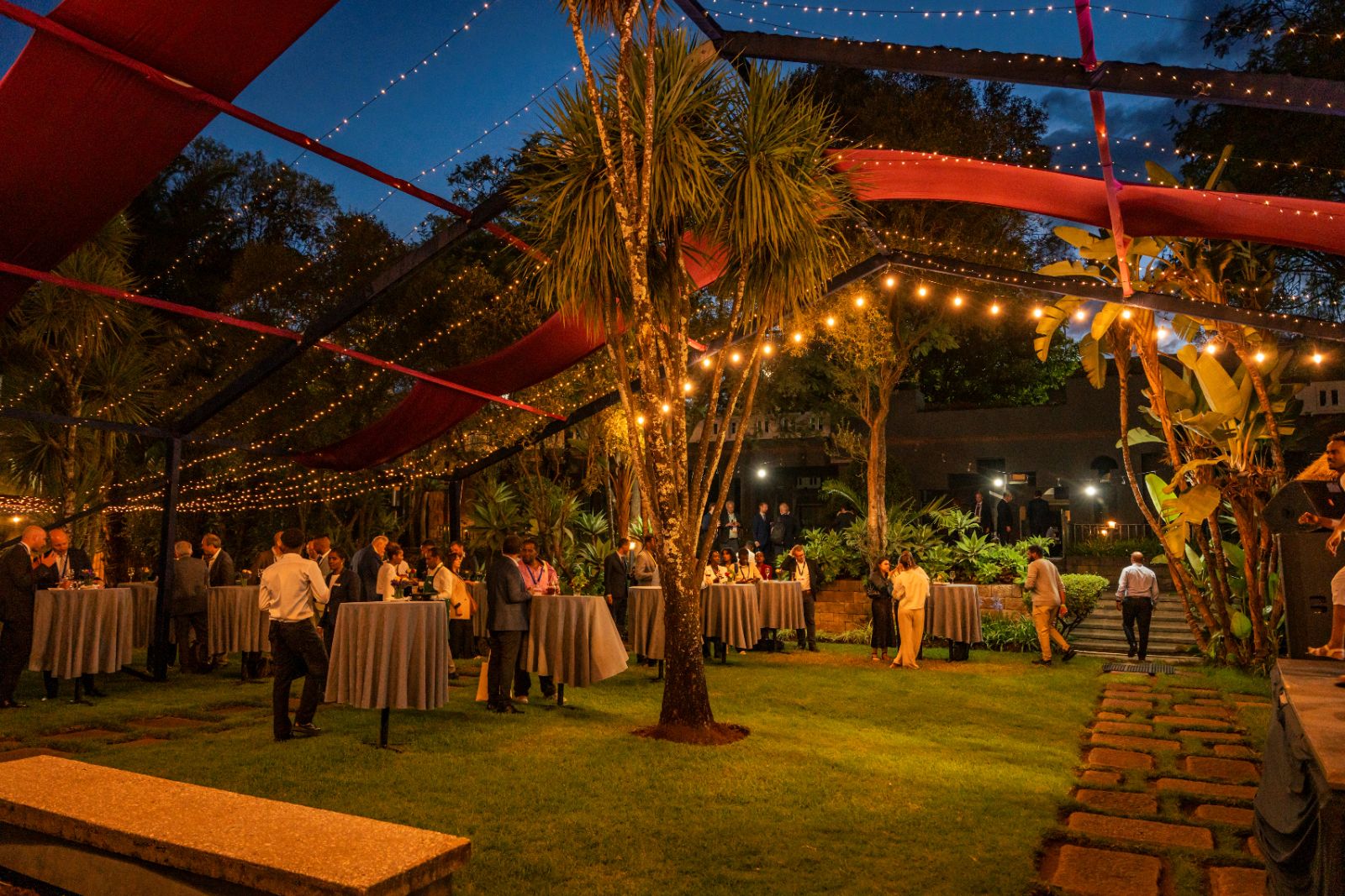 Garden set at dusk, tables dressed and waiting