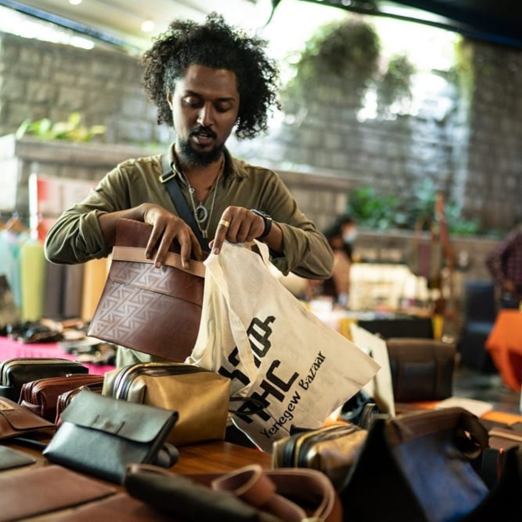Leather goods vendor packing an order